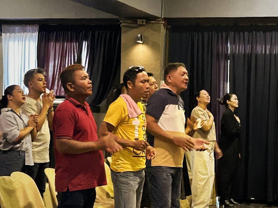 Men of MCOF singing together in worship