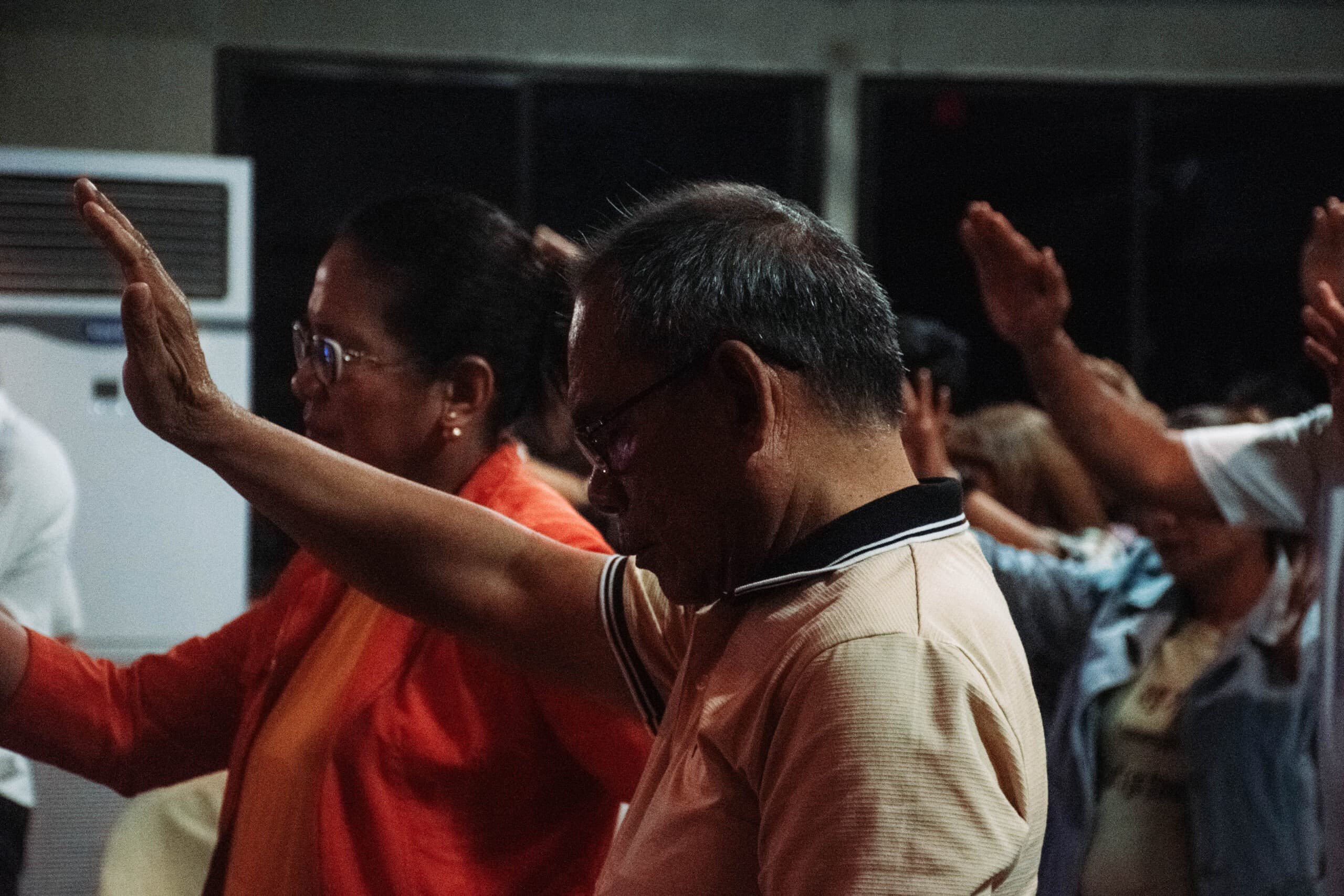 Members lifting their hands in worship